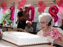 Mary Cousins, ex-W1GSC, admires her 108th birthday cake on September 20. [Island Nursing Home and Care Center photo]